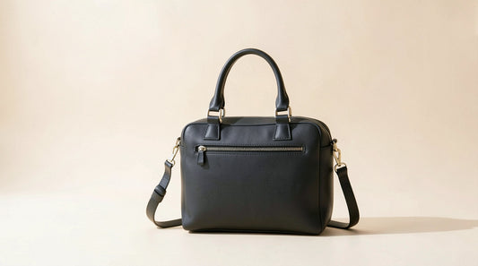 Black leather ita bag on a bright studio background